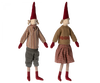 Two Maileg Christmas Pixy (Size 4) with pointed red hats, one dressed in a striped shirt and gray pants, the other in a sweater and plaid skirt, standing against a white background as an exclusive Christmas decoration