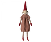 A Maileg Christmas Pixy (Size 6) with a long, pointy red hat, striped red and white legs, red mittens, and a rustic red dress made from exclusive materials, isolated on a black background.