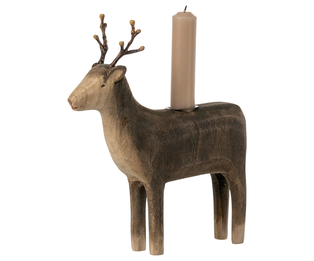A Maileg Wooden Reindeer Candle Holder with a candle mounted on its back, displayed against a white background. The reindeer features detailed carving and a rustic finish.