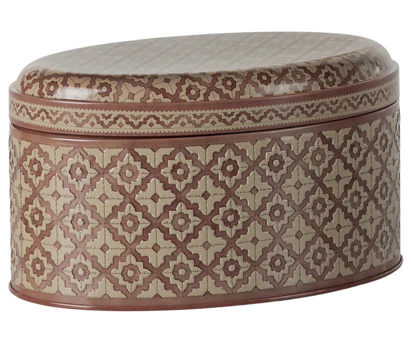 This oval-shaped Maileg Metal Box from the Winter Wonderland Collection showcases a tan and brown geometric pattern. The repeating symmetrical design enhances the artistic appeal of both the lid and base, making it an ideal choice for storing Christmas sweets.