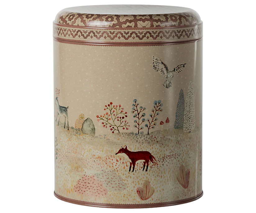 From the Winter Wonderland Collection, the Maileg Metal Box, 2 Piece Set features a decorative cylindrical tin that captures a whimsical woodland scene with a red fox, deer, and owl among trees on a dotted beige background. Ideal for storing Christmas sweets, it includes a lid with a patterned red and white border along the top edge.