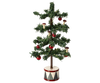 The Maileg Christmas Tree, Mouse is a charming small decorative tree featuring sparse green branches, red berries, and tiny mushroom ornaments. It glows with warm LED bulbs and stands on a round base adorned with a red and white diamond pattern, making it the perfect companion to a festive gingerbread house.