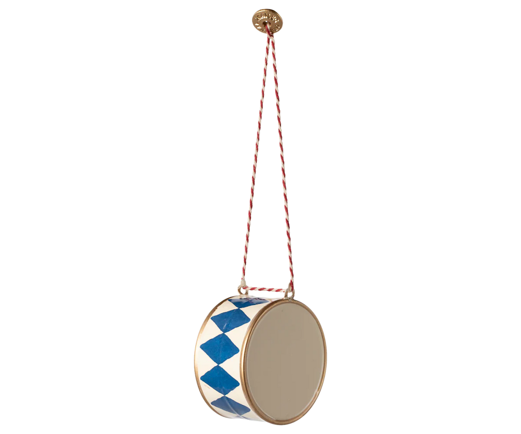 The Maileg Metal Ornament - Large Drum, Dark Blue features hand-painted blue diamond patterns and hangs from a red and white cord—an ideal festive ornament for your Christmas tree.