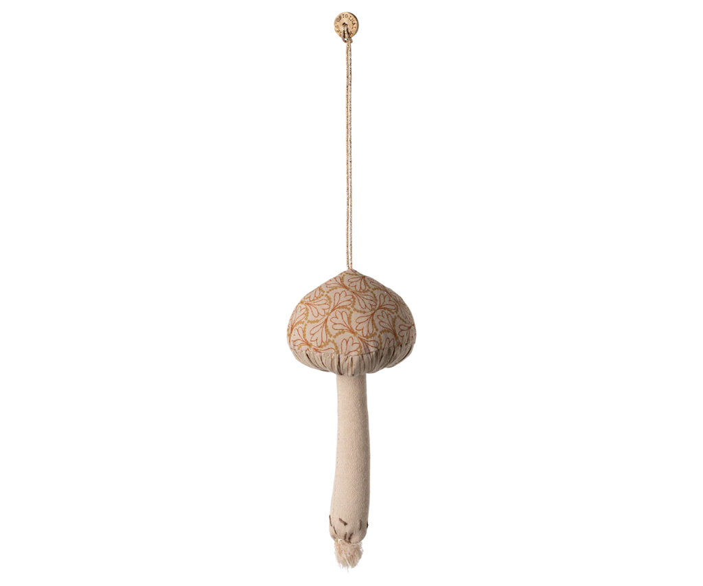 The Maileg Christmas Fabric Ornament, Mushroom - Winter Heart, features a plush mushroom with a beige stem and patterned cap hanging by a string from a circular knob—perfect as a charming ornament for your Christmas tree or seasonal décor.