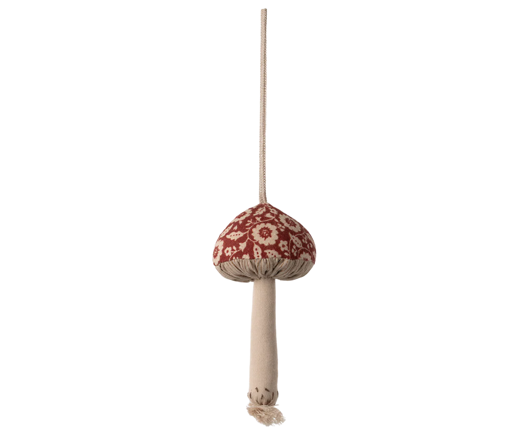 The Maileg Christmas Fabric Ornament, Mushroom - Winter Flower - Red features a beige stem and a red cap with white floral patterns, hanging by a beige string—perfect for adding festive charm to your Christmas tree.