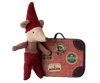 The Maileg Christmas Mouse, Baby in Suitcase, dressed in red clothing and a pointed hat, stands beside a travel suitcase adorned with stickers such as "Chatham Paris," "Camembert Maille," and circular stamps, creating a festive scene.