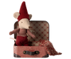 A cheerful Maileg Christmas Mouse, Baby in Suitcase, dressed in a red knit hat and outfit, is nestled in an open vintage-style travel suitcase. A warm knitted blanket decorates the patterned interior, perfectly complementing the red checkered design on the exterior.