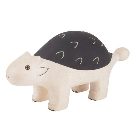A wooden toy shaped like a smiling Ankylosaurus, handcrafted by Bali artisans from Albizia wood, featuring a light beige body and a dark shell with curved white lines, photographed on a white background.