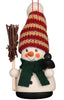 The Christian Ulbricht Ornament - Snowman showcases a hand-painted festive snowman wearing a striped red and beige knitted hat with a green scarf. It holds a bundle of twigs as a broom, with a small black bird perched on its side.