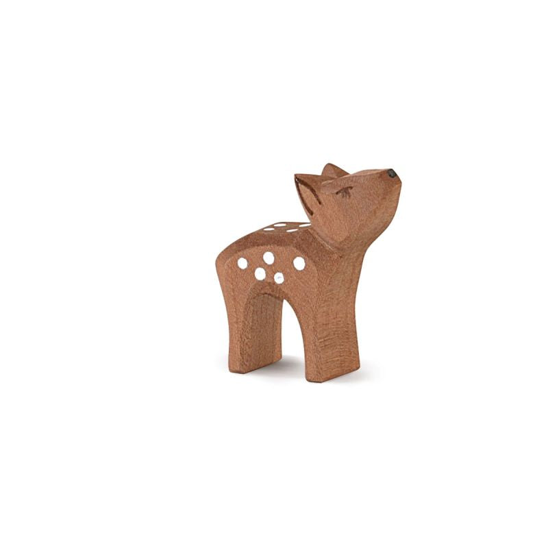 The Ostheimer Deer - Small Head High is a small, handcrafted wooden figurine shaped like a deer. It features a light brown finish with white spots on its back and stands with its head slightly tilted upwards, as if looking up, making it perfect for imaginative play.