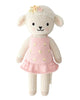 Cuddle + Kind Eleanor the Lamb is a hand-knit, fair trade doll from Peru, featuring a friendly lamb in a pink dress with yellow and floral accents, black eyes, a small nose, and a gentle smile.