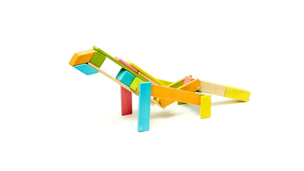 Colorful heirloom-quality toy airplane made from Tegu 24 Piece Magnetic Wooden Block Set - Sunset, displayed against a white background.