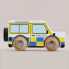 No. 40 GT250 Bobby | Made in England is a wooden police car inspired by a classic British patrol vehicle, featuring yellow and blue checkered details, two sturdy wooden wheels, and “POLICE” written on the side—perfect for imaginative play against a plain background.