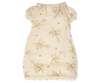 A small white Maileg Extra Clothing: Nightgown For Big Sister Mouse with short ruffled sleeves featuring a pattern of light pink and green floral branches, perfect for a pyjamas party. The nightgown has a scalloped hem at the bottom, making it ideal for your big sister mouse.