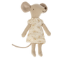 A soft toy mouse stands upright, dressed in a nightgown adorned with a delicate floral print. The Maileg Extra Clothing: Nightgown For Big Sister Mouse has large round ears, a long tail, and stitched facial features. The background is plain white.