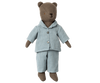 Meet Teddy Dad, a charming stuffed bear dressed in the Maileg Extra Clothing: Pyjama for Teddy Dad, featuring a light blue and white striped pajama set complete with buttons. His dark brown fur beautifully complements the top's collar. This adorable ensemble is perfect for display; note that the outfit is available for purchase separately.