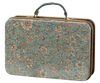 A rectangular vintage-style suitcase with a hinged handle. The suitcase is adorned with an intricate floral pattern featuring cream-colored flowers and leaves on a teal background. Inside, you'll find a matching collar and leash set for your soft plush dog, perfect for stylish travels: the Maileg Puppy Accessories - Blue.