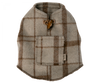 A gray and brown plaid wool Maileg Puppy Poncho with a leather toggle closure at the neck and a small rectangular pocket on the back. Featuring a convenient small tail hole, the fabric tag on the side reads "Found." The poncho is laid flat on a white background.
