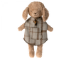 A Maileg Puppy Poncho is wearing a knitted sweater with a pocket and toggle button. The bear has floppy ears, soft textured fur, and even sports a small tail hole, giving it a cute and cozy appearance.