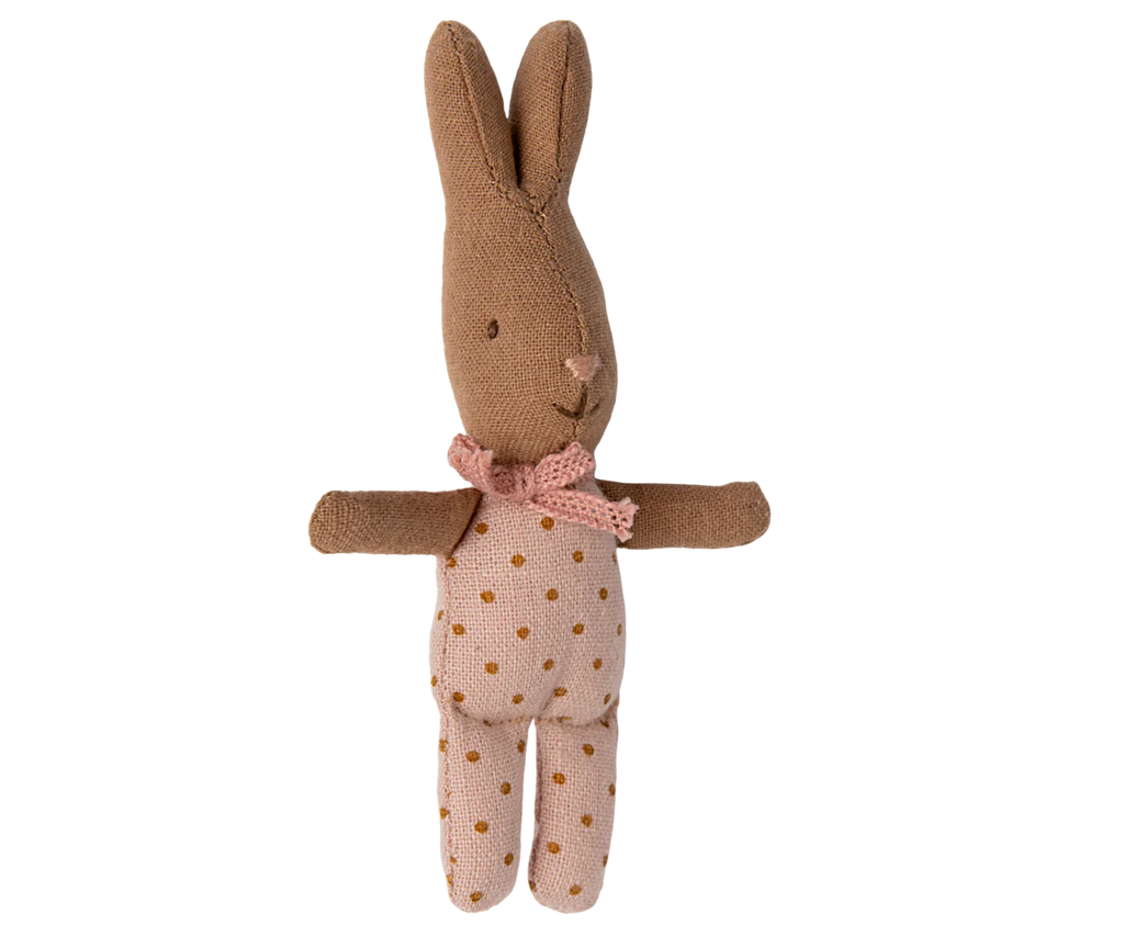 The Maileg My Rabbit - Dots is a plush bunny toy featuring a brown body with pink polka-dotted fabric on its belly and legs, complete with a pink bow around its neck and upright ears.