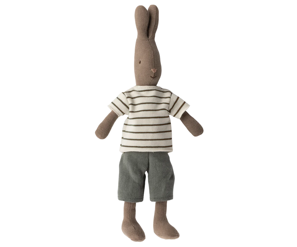 A Maileg Rabbit Size 2, Brown - Striped Blouse and Pants, crafted from soft natural fabrics and recycled polyester, dons a striped short-sleeve shirt and grey shorts. Standing upright with its arms and legs slightly apart, the Maileg Rabbit Size 2, Brown - Striped Blouse and Pants features long ears and a stitched facial expression.