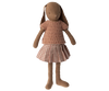 A Maileg Bunny, Size 3 - Knitted Shirt & Skirt wearing a knitted pink sweater and a checkered skirt. The rabbit, made from soft natural fabrics, has long ears and stands upright with its arms extended slightly to the sides.