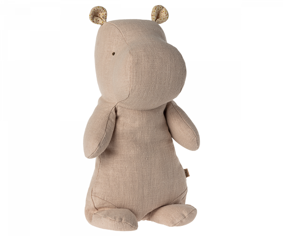 A Maileg Medium Hippo Stuffed Animal - Light Rose, made from the softest recycled polyester, stands on its hind legs with small dotted ears. The toy has a smooth texture and minimal facial features, giving it a simple, yet cute appearance — perfect for joining your Safari friends collection.