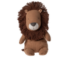 The Maileg Lion Stuffed Animal from the Safari Friends collection sits upright, featuring a brown body with a mane of thick, dark brown yarn. Its simple, embroidered face showcases small eyes and a stitched nose and mouth, highlighting exquisite handmade details.