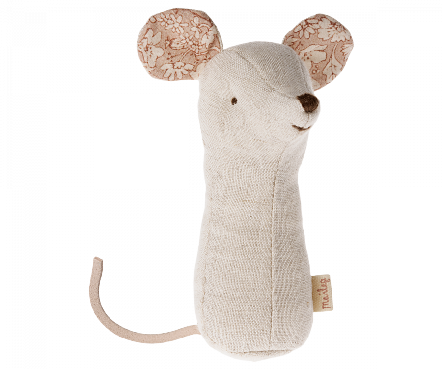 A fabric mouse toy with a beige body and floral-patterned ears, crafted from soft fabrics. The toy features a simple stitched face, a small tail, and is part of the charming Maileg Lullaby Friend Rattles, Mouse - Nature collection. A small tag is attached to its side for an added touch.