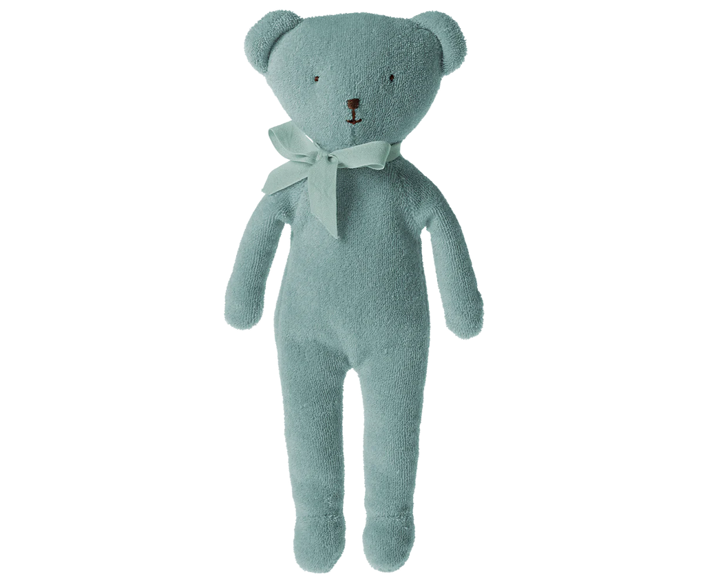 The Maileg Teddy - Blue is a soft, light blue teddy bear crafted from plush fabric, featuring a simple stitched face, long limbs, and adorned with a matching ribbon around its neck.