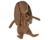 Maileg Bunny - Chocolate Brown: A soft bunny toy with floppy ears and a rustic orange bow around its neck. Made from recycled polyester, its inner ear lining features a floral pattern. The bunny, sitting upright with a neutral expression, also has magnets in its hands for added playfulness.