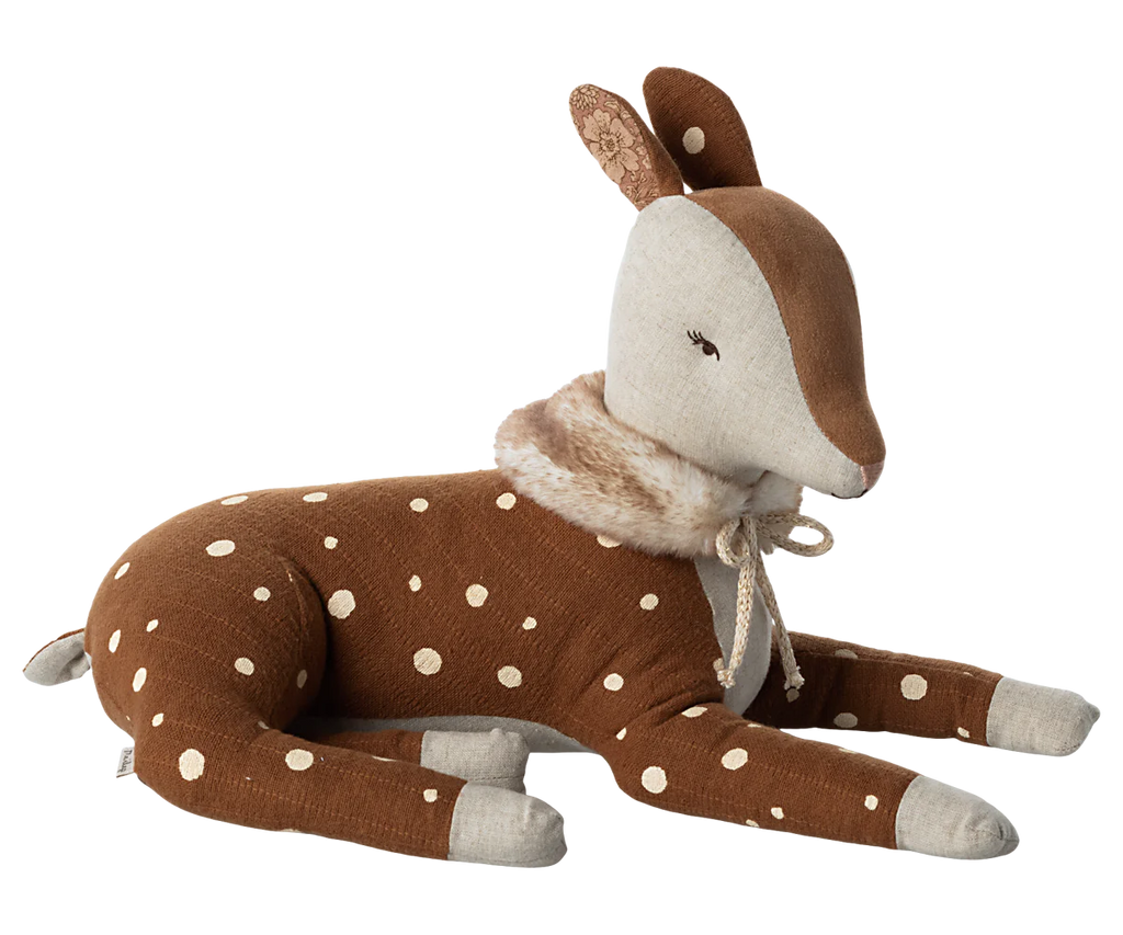 A soft, plush Maileg Cosy Bambi Deer in off-white fur with delicate white spots. It features a light beige face and inner ears, closed eyes adorned with embroidered eyelashes, and a white fuzzy collar around its neck. This classic toy is lying down with legs outstretched.