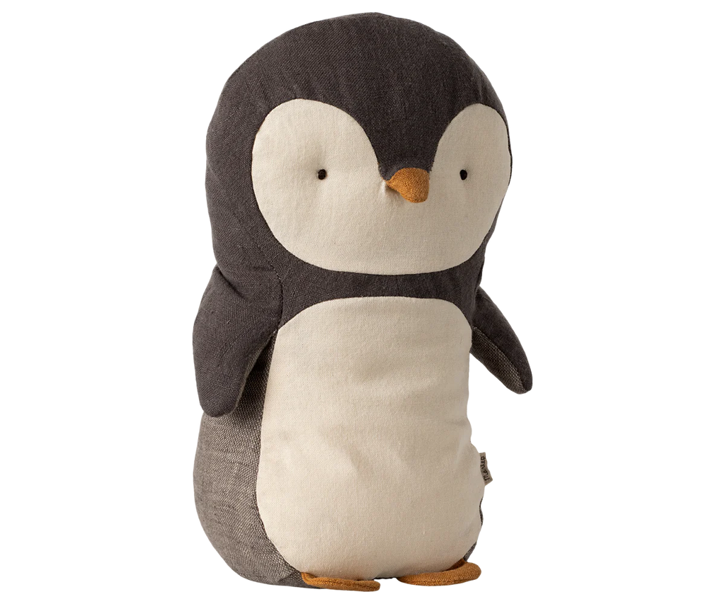 The Maileg Penguin Stuffed Animal - Small is a cuddly toy made from gentle fabrics, showcasing a dark gray back and wings, a white belly, and an orange beak and feet. Suitable for all ages, this charming penguin stands upright with simple embroidered eyes.