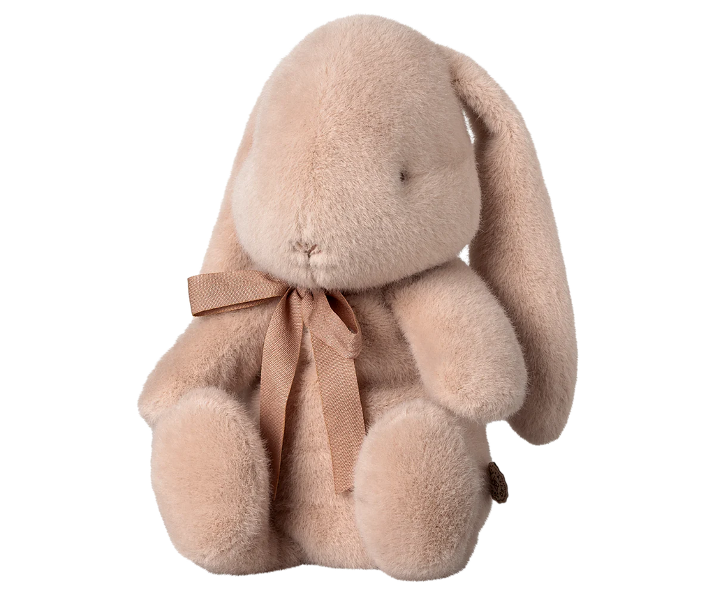 The PRE-ORDER Maileg Plush Bunny - Light Powder, shipping in February, is an adorable plush companion with long ears, a small nose, black eyes, soft fabric, and a matching brown ribbon around its neck.