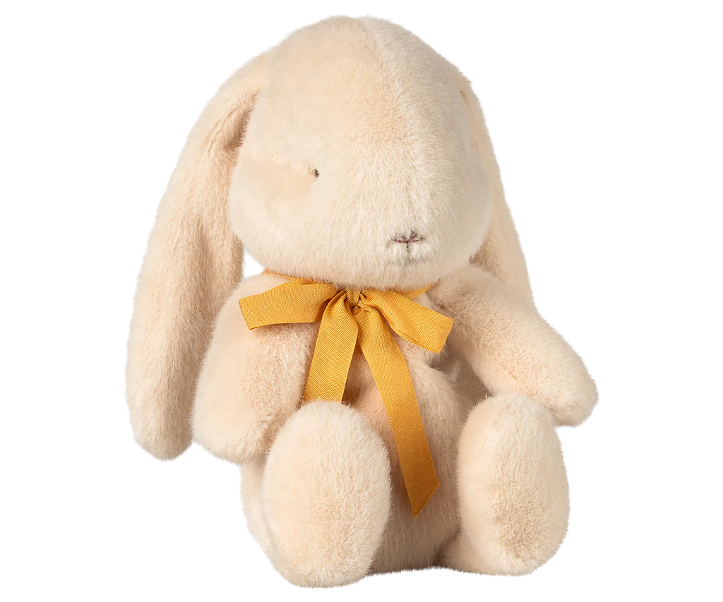 The Maileg Plush Bunny - Small Cream, available for pre-order and shipping in February, features floppy ears, a yellow neck bow, a cream color, is made from soft recycled polyester and has embroidered closed eyes for a peaceful look.