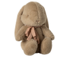 The Maileg Plush Bunny in Carry Cot is a soft dusty brown bunny with long floppy ears, stitched features, and a pink ribbon bow around its neck, sitting upright against a plain white background.