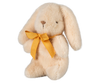 The PRE-ORDER: Maileg Plush Bunny - Mini Cream features a fluffy beige design, crafted from soft plush fabric. It sits upright with long ears framing a charming yellow bow around its neck. Ships in February.