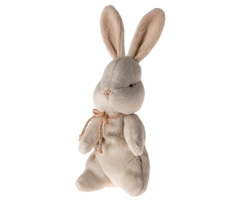 The Maileg My First Bunny - Dusty Rose, featuring soft plush fabric and large, upright ears, stands against a plain white background. Its simple stitched face and delicate rustic ribbon make it an ideal baby shower gift.