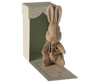 The Maileg My First Bunny - Brown is a soft plush bunny with a silver bow, nestled in a pastel green polka dot gift box featuring scalloped edges, “My first bunny” text, and an adorable bunny illustration on the base.