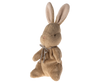 The Maileg My First Bunny - Brown is a light brown plush with long ears, black stitched eyes, and a silver bow, sitting upright against pastel stripes—perfect as a soft plush for “my first bunny” moments.