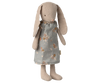 The Maileg Bunny, Size 1 - Classic - Dress is a miniature toy with long floppy ears, wearing a blue-gray floral dress. Made from soft natural fabrics, it features simple stitched facial details and stands upright.