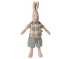 The Maileg Rabbit, Size 1 - Classic, wears a plaid shirt and denim shorts and stands upright with outstretched arms, making it perfect for pairing with miniature furniture.