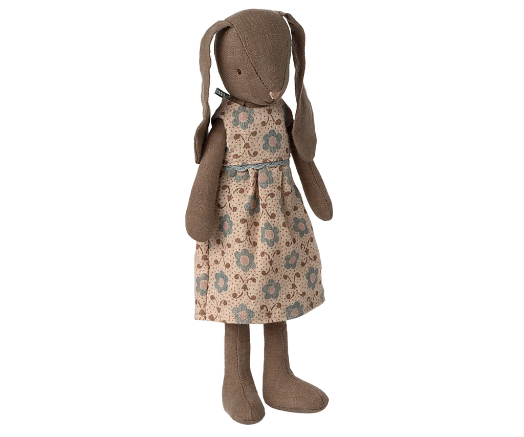 The Maileg Bunny, Size 2 - Brown - Dress features a soft brown fabric with long ears and a beige dress decorated with blue and brown floral patterns, displayed upright against a plain background.