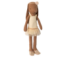 The Maileg Bunny, Size 2 in Chocolate Brown, wears a cream ballet suit and skirt and stands upright like a graceful dancer against a blurred background.