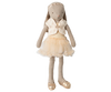 The Maileg Bunny, Size 3 - Classic, is dressed in a cream ballet suit and skirt with a lace headband and gold ballet shoes, standing upright against a plain background.