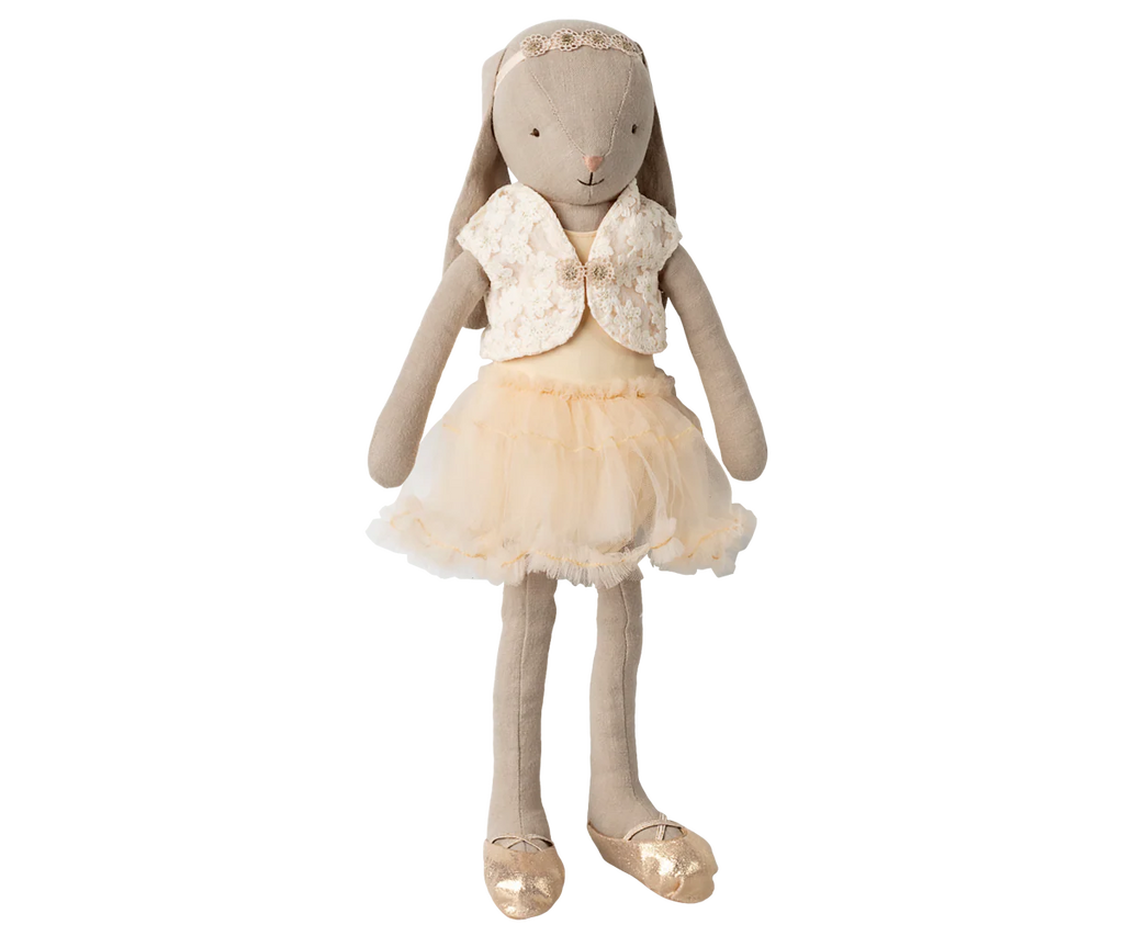 The Maileg Bunny, Size 3 - Classic, is dressed in a cream ballet suit and skirt with a lace headband and gold ballet shoes, standing upright against a plain background.