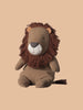 The Maileg Safari Friends Big Lion, available for pre-order and shipping in February, sits against a beige background. It features a fluffy mane, handmade details, tiny ears, and a small tail. Made from soft fabric in warm brown hues, it's part of the charming Safari Friends Collection.