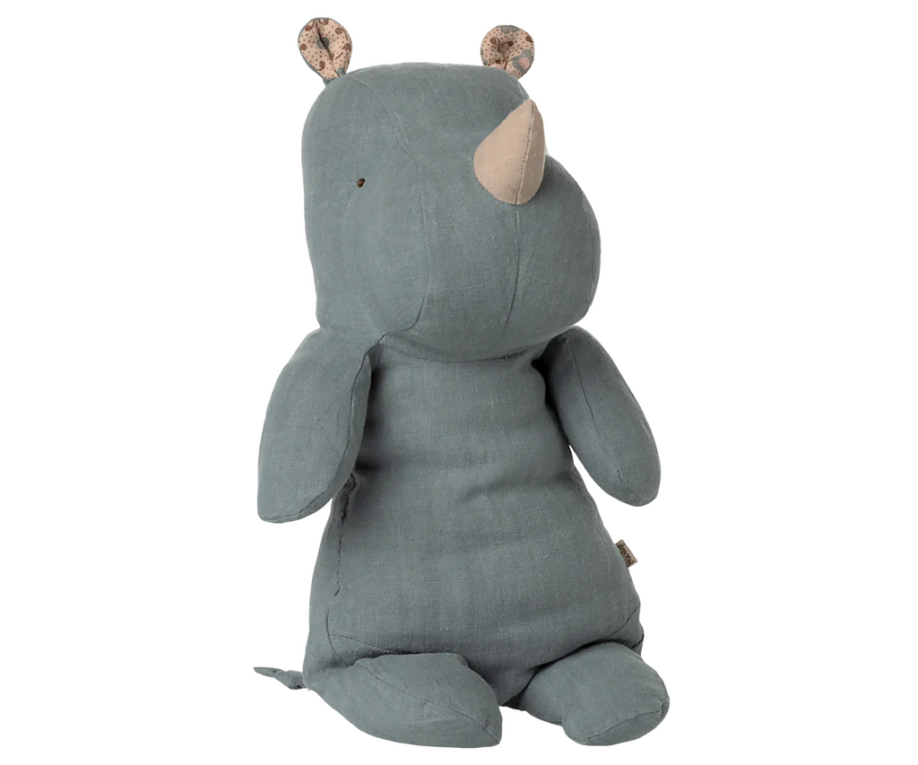 The Maileg Medium Rhino - Dusty Blue, from the Safari friends collection, is a soft plush toy made with recycled polyester and patterned ear fabric, shown sitting upright against a plain background.