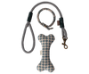 A textured gray and white leash with a matching collar is paired with a blue and white checkered Maileg Puppy Supply Accessories - Blue bone toy, perfect for your soft plush dog.