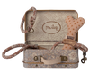 The Maileg Puppy Supply Accessories - Rose set includes a small metal suitcase with a charming Maileg print, and features a pink polka-dot dog bone toy, matching leash, and collar—perfect for your plush dog. "Maileg" is labeled inside the lid.